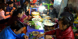 Locals eat at Da Lat night market.