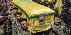 Hezbollah fighters carry the coffin of their comrade,senior commander Taleb Sami Abdullah,55,known within Hezbollah as Hajj Abu Taleb,who was killed late Tuesday by an Israeli strike in south Lebanon.