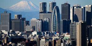 Mount Fuji and the Shinjuku skyline seen from an observation deck in Tokyo,Japan.