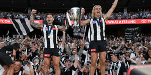 Collingwood’s Jamie Elliott and Darcy Moore celebrate their premiership victory. Fans want loyalty among their sporting stars but it’s no good as a consumer.