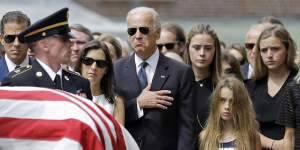 Joe Biden at his son Beau’s funeral next to his widow Hallie and brother Hunter.