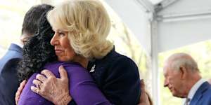 The Queen embraces a relative of a victim of the 9/11 attacks at the memorial.