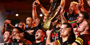 The Panthers celebrate with the NRL premiership trophy after victory in the 2021 grand final in Brisbane.