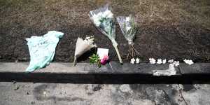 Flowers are left at the scene of a car fire which claimed the lives of a mother and her three young children.