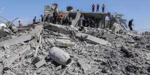 People inspect damage and recover items from their homes following Israeli airstrikes in Rafah,Gaza,on Wedneday.
