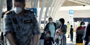 NSW police and Australian Defence Force personnel process people who arrived at the Sydney International Airport from Colombo in Sri Lanka. Mascot,NSW. 1st October,2020. Photo:Kate Geraghty 