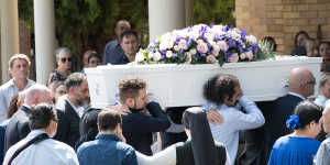 Pallbearers carry Veronique Sakr's coffin into the service.