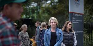 Kasey Thompson (centre) and other parents outside Richmond West Primary School,where tensions have spiked over the nearby safe injecting room.
