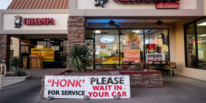 A sign instructs customers to wait in their cars outside a restaurant in El Paso,Texas'worst spot for COVID infections.