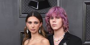 Katarina Deme,left,and The Kid Laroi arrive at the 64th Annual Grammy Awards.