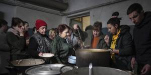 People queue to receive hot food in an improvised bomb shelter in Mariupol,Ukraine on March 7. 