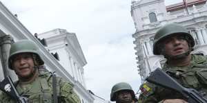Soldiers patrol outside the government palace during a state of emergency in Quito.