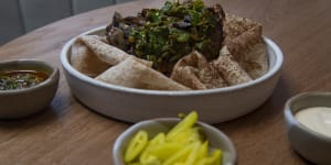 Lamb neck shawarma with tarator,pickles,chermoula and flatbread. 