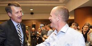 Cr Quirk shakes hands with his mayoral predecessor,Campbell Newman.