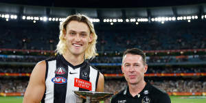 Collingwood captain Darcy Moore and coach Craig McRae with the Anzac Day trophy. 