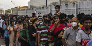 People wait in queue to enter the official residence of president Gotabaya Rajapaksa three days after it was stormed by anti-government protesters in Colombo.