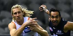 Eddie Betts of the Blues and Nick Haynes of the Giants compete for the ball.