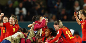 The Spanish team celebrate Olga Carmona’s goal during Sunday’s Grand Final. 