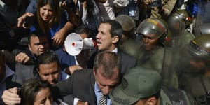 Venezuela's Guaido forces his way into parliament,takes oath in darkness