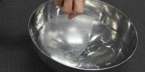 Briefly dip one side of the rice paper roll into a bowl of water,rotating it to moisten the wrapper.