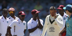 Usman Khawaja leaves the field after being hit on the jaw by a bouncer in Adelaide on Friday.