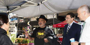 Indigenous leader Noel Pearson with federal MP Julian Leeser (centre) and state MP Matt Kean speaking to Christa from the honey stall.
