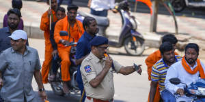 A policeman takes an icy pole to beat the heat as he directs traffic during a Hindu religious procession to mark Hanuman Jayanti festival in Hyderabad,India,last week.