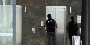 ATO officers enter Number 10 Herb Elliott Drive,the headquarters of businesses related to the Plymouth Brethren Christian Church,in Olympic Park,on March 19.