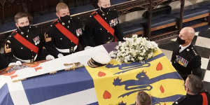 Britain’s Queen Elizabeth II looks on the flag-draped coffin as she sits alone in St George’s Chapel during the funeral of Prince Philip at Windsor Castle on April 17.