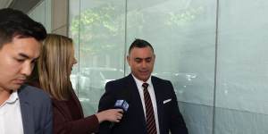 Former NSW deputy premier John Barilaro,centre,outside the ICAC during the lunch break on Monday.