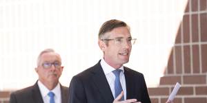NSW Premier Dominic Perrottet,with Health Minister Brad Hazzard (behind) announces changes to COVID isolation rules on Wednesday.
