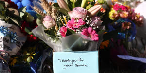 Tributes are seen at Chinchilla Police station in Chinchilla,Queensland,Wednesday,December 14,2022. Police have shot dead three people at a remote property on Queensland’s Darling Downs after an ambush in which two officers and a bystander were killed. (AAP Image/Jason O’Brien) NO ARCHIVING AAP fee for use 