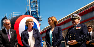 Thoroughly charmed:French President Emmanuel Macron made sure then defence minister Linda Reynolds,seen here with her French counterpart Florence Parly,was invited to the launch of the first of France’s newest class of nuclear-powered submarines,the Barracuda,in Cherbourg in 2019. 