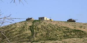 New position of the Suleyman Shah mausoleum is pictured from Turkish side of the border as Turkish army vehicles move inside Syria.