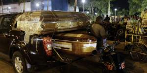 Coffins for the bodies of inmates sit on a truck outside the Guayaquil morgue.