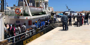 Rescued migrants desembark from the Mare Jonio rescue ship of the Italian NGO Mediterranea Saving Humans as it docked at the port of the Italian island of Lampedusa,southern Italy.
