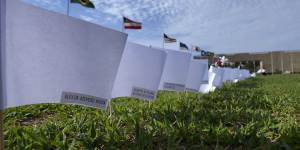 The names of people who died of COVID-19 cover white flags in a field as part of a protest against the government’s health policies outside the National Congress in Brasilia,Brazil.