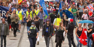 Angry protesters marching through Melbourne’s CBD in late 2021. 