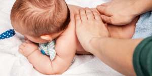 Baby receives manual therapy at home.
