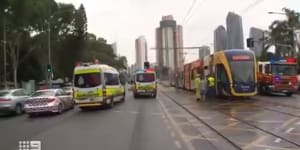 Woman threatened at gunpoint after stolen car slams into Gold Coast tram