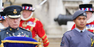 A member of the Royal Air Force Air Cadets,right,holding the Commonwealth of Nations’ Globe as it arrives at the Tower of London. The globe will be used in the lighting of the Principal Beacon at Buckingham Palace.