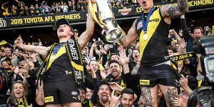 Liam Baker (left) celebrates the Tigers’ 2019 premiership with star teammate Dustin Martin.