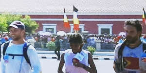 From left,Dan Gosling,Aguida Amaral and Luke Gosling cross the finish line in Dili in 2003.