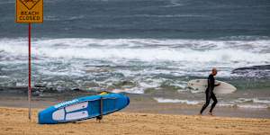 A beach closure sign didn’t stop some surfers heading out into the water.
