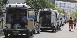 Ambulances line up waiting for their turn to deliver patients to a dedicated COVID-19 hospital in Ahmedabad,India.