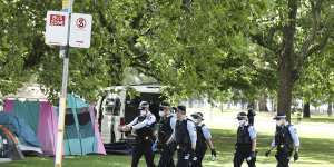 Police at the perimeter of the protest camp site between Old Parliament House and the National Portrait Gallery in Canberra on Friday.