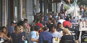 Patrons enjoy the cafes at Bronte Beach on a busy Sunday.