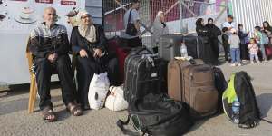 Palestinians wait at the border crossing between the Gaza Strip and Egypt in Rafah on Wednesday.