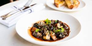Snail meurette - snails in red wine and bacon sauce.