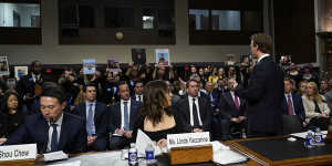 Meta CEO Mark Zuckerberg turns to address the audience during a Senate Judiciary Committee hearing on Capitol Hill in Washington to discuss child safety. TikTok CEO Shou Zi Chew and X CEO Linda Yaccarino listen.